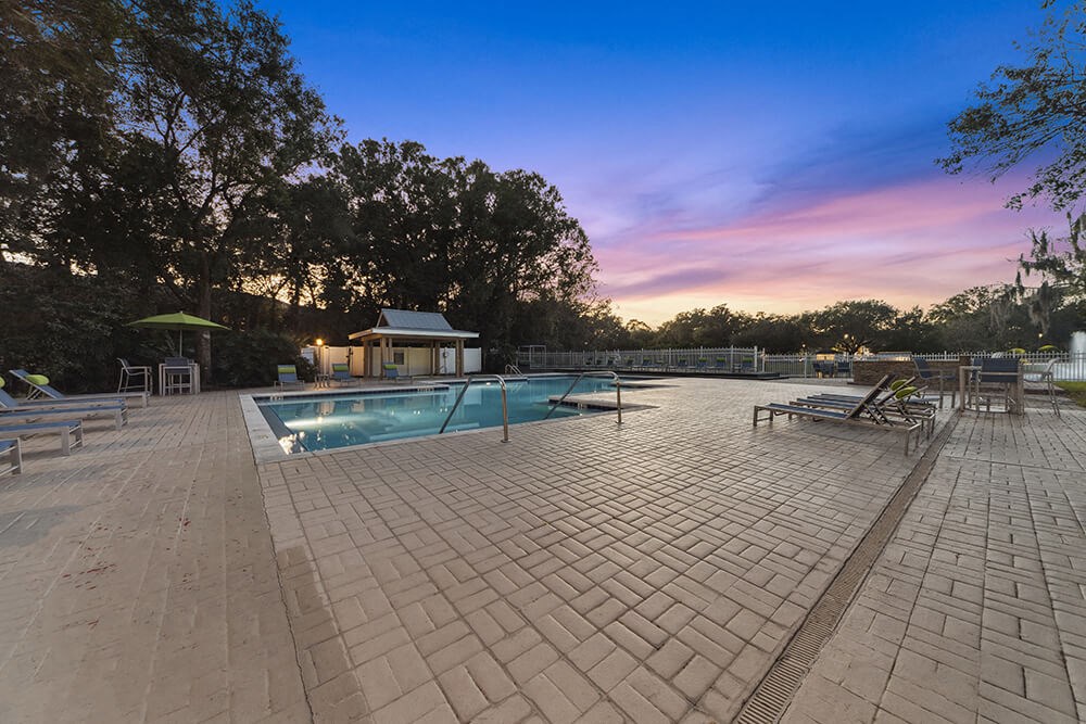Community Swimming Pool with Pool Furniture at Walden Lake Apartments in Plant City, FL.