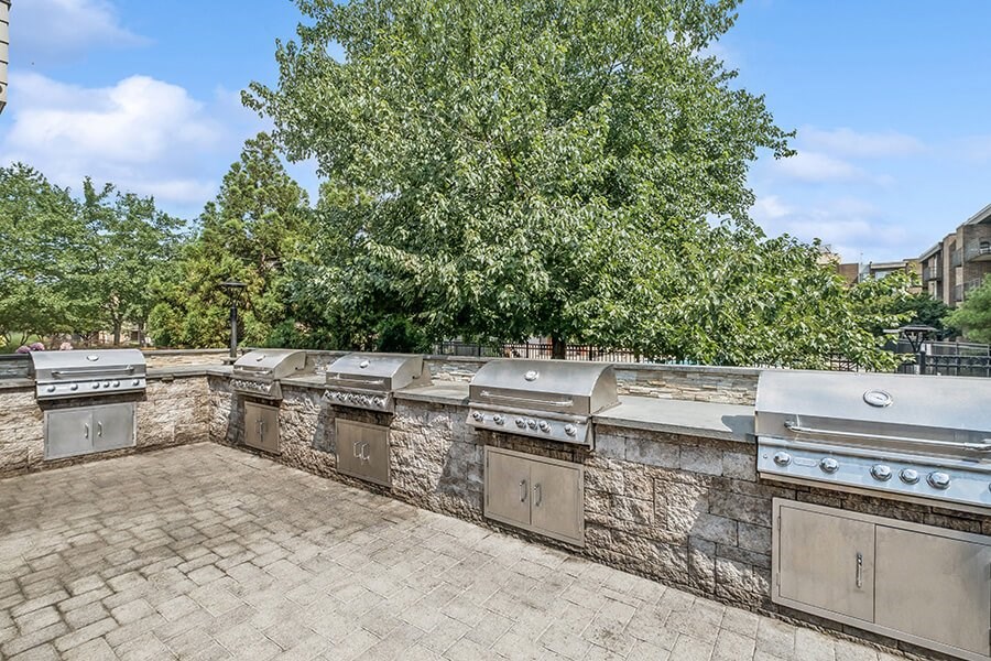Outdoor BBQ Area with Five Grills at Mason Van Dorn Apartments located in Alexandria, VA.
