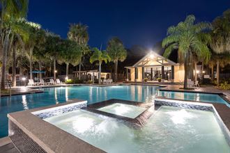 Community Swimming Pool with Pool Furniture at Caribbean Breeze Apartments in Tampa, FL.