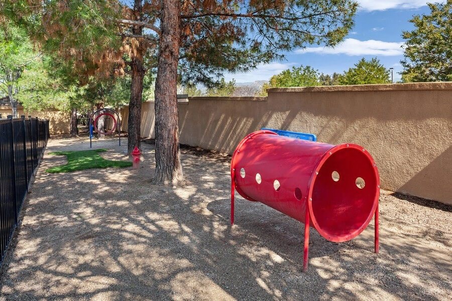 Fenced dog park with agility equipment at Reserve at Rancho Apartments