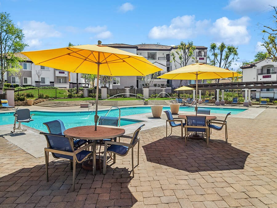 Community Swimming Pool with Pool Furniture at Reserve at Rancho Apartments located in Moreno Valley, CA.