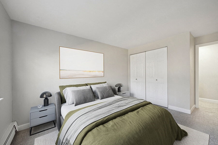 Model Bedroom with Carpet and Hallway View at Middlesex Crossing Apartments in Billerica, MA.