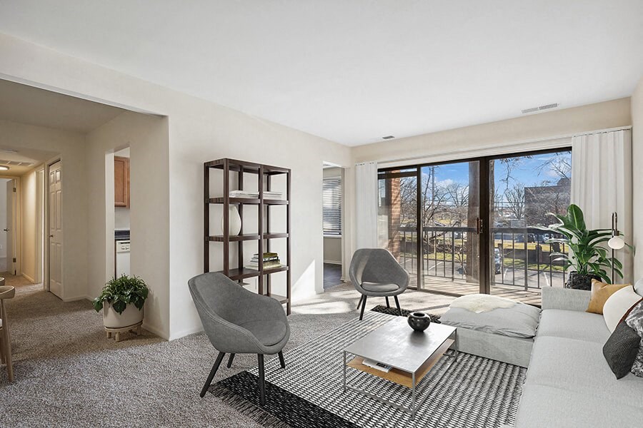 Model Living Room with Carpet and Patio Accessibility at Spring Parc Apartments in Silver Spring, MD.