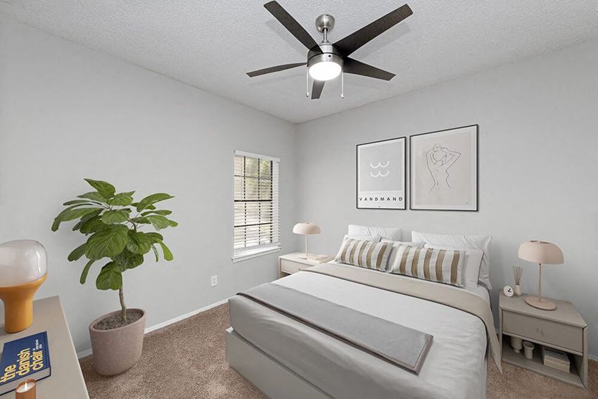 Model Bedroom with Carpet and Window View at Heatherstone Apartments in Dallas, TX.
