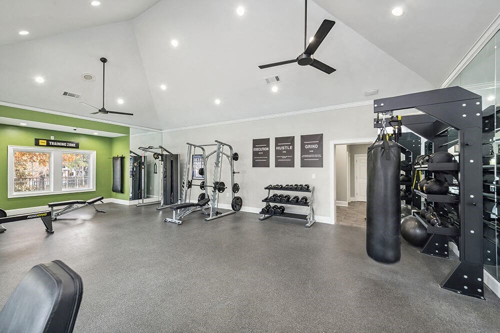Community Fitness Center with Equipment at Bridges at Oakbend Apartments in Lewisville, TX.