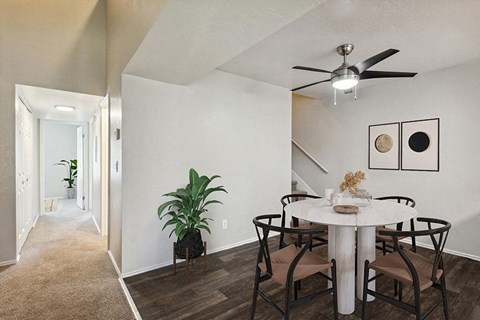Model Dining Room with Wood-Style Flooring & View of Hallway at Broadmoor Village Apartments in Salt Lake City, UT.