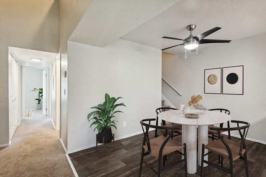 Model Dining Room with Wood-Style Flooring & View of Hallway at Broadmoor Village Apartments in Salt Lake City, UT.