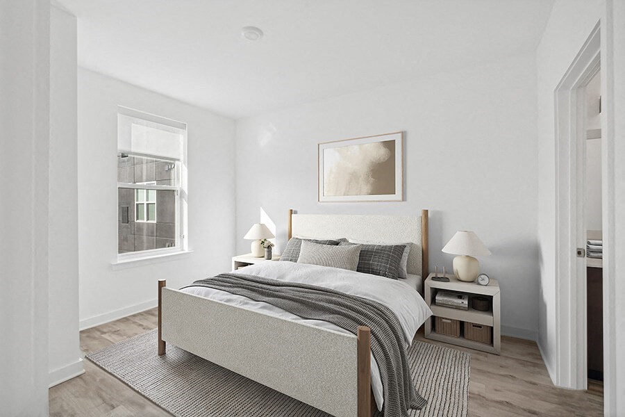 Model Bedroom with Wood-Style Flooring  and attached Bathroom at Stella Apartments located in New Carrollton, MD.