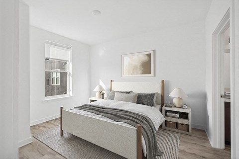 Model Bedroom with Wood-Style Flooring  and attached Bathroom at Stella Apartments located in New Carrollton, MD.