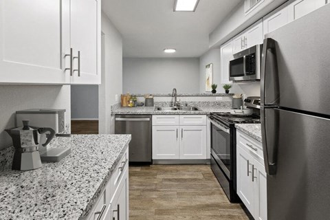a kitchen with granite counter tops and stainless steel appliances