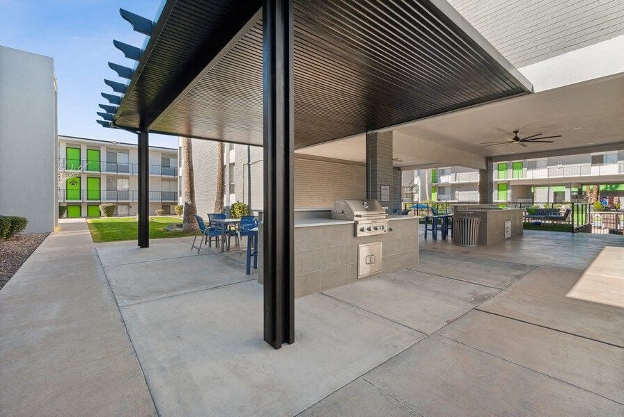Covered outdoor kitchen space with BBQ grills