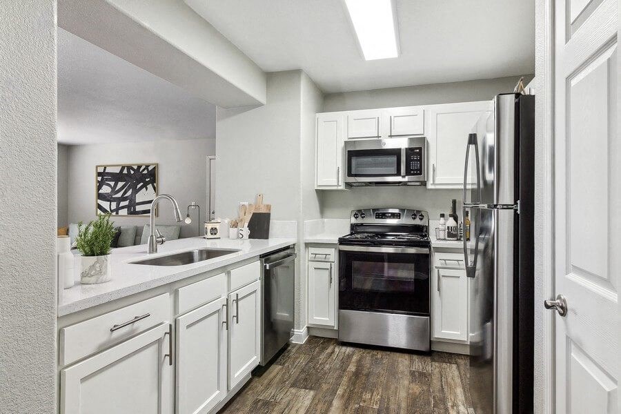 Model kitchen with white cabinets and stainless steel appliances