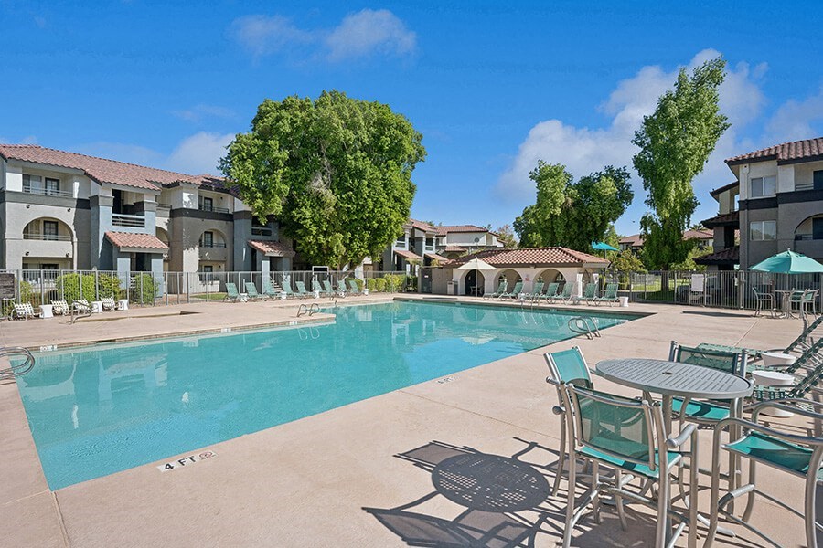 Community Swimming Pool with Pool Furniture at Stillwater Apartments located in Glendale, AZ.