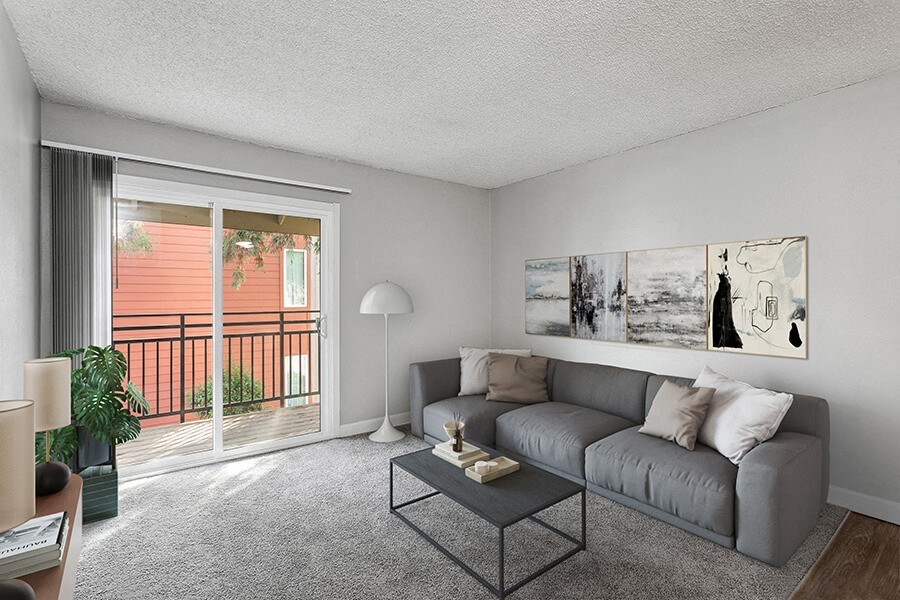 Model Living Room with Carpet and Patio Accessibility at The Archer Apartments in Sacramento, CA.
