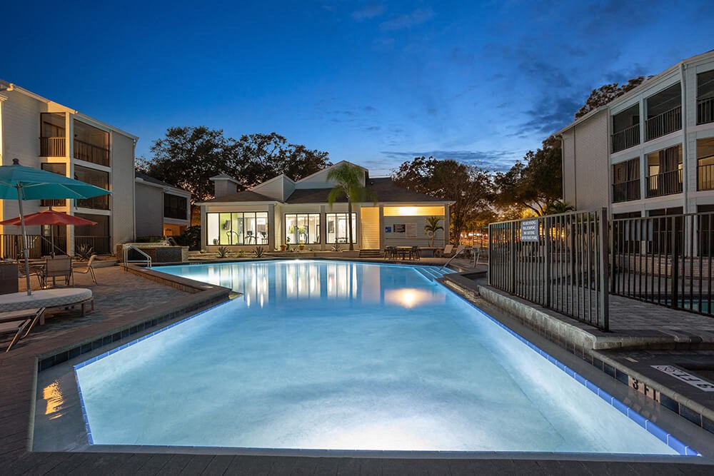 Community Swimming Pool with Pool Furniture at Haven at Water's Edge Apartments in Tampa, FL.
