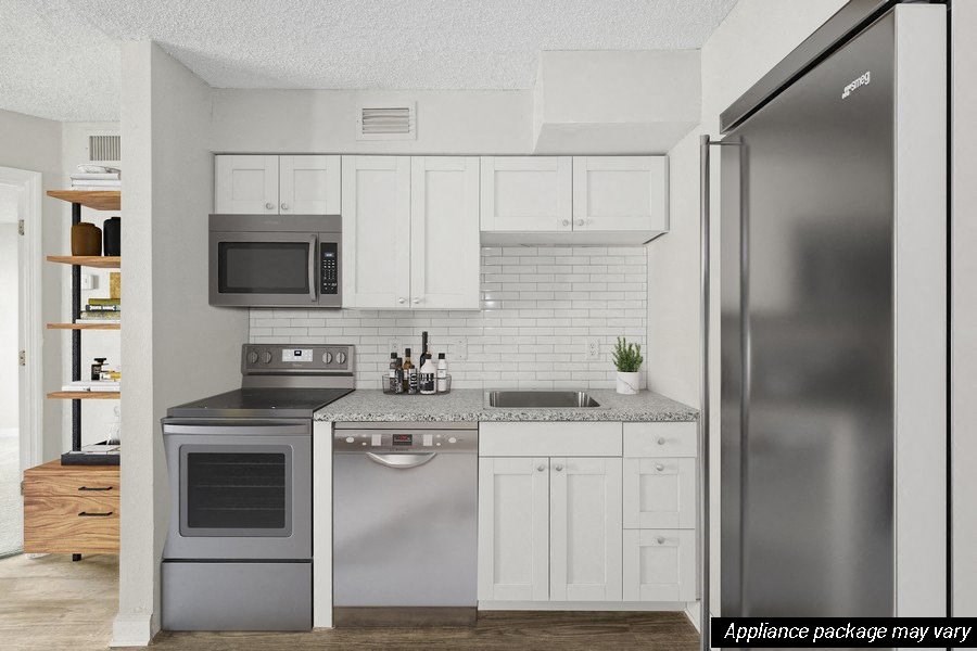 Model kitchen with white cabinetry