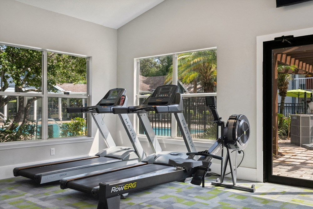 Fitness center with treadmills at Retreat at Crosstown Apartments