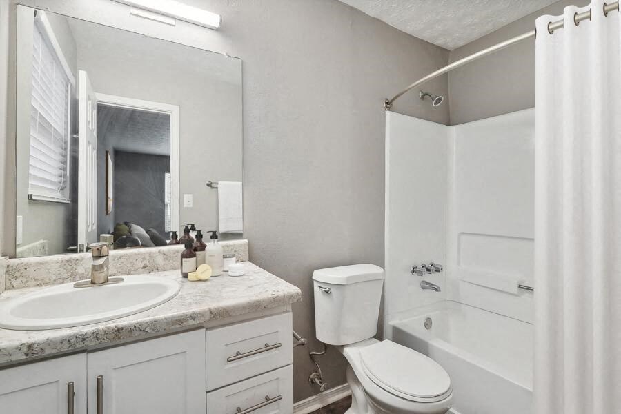 a bathroom with a sink toilet and a bath tub