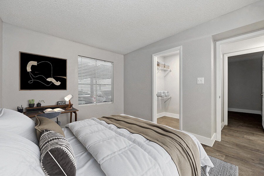 Model Bedroom with Wood-Style Flooring and Walk In Closet at Crystal Creek Apartments located in Phoenix, AZ.