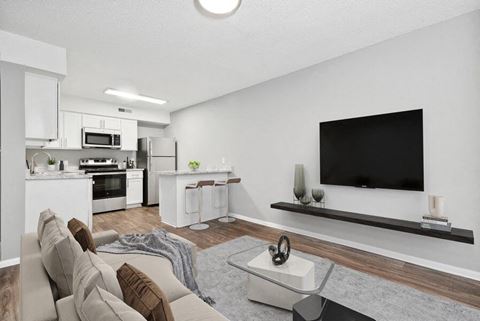 Model living room with view of open kitchen area