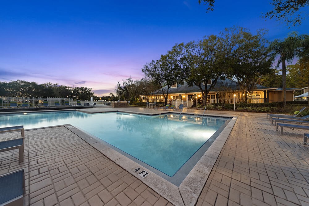 Community Swimming Pool with Pool Furniture at Walden Lake Apartments in Plant City, FL.