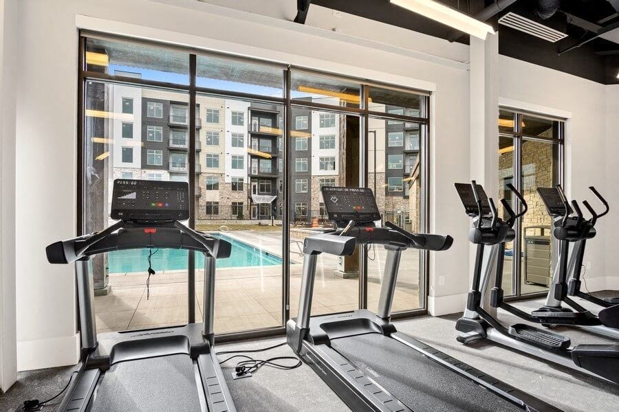 treadmills with view of pool in gym