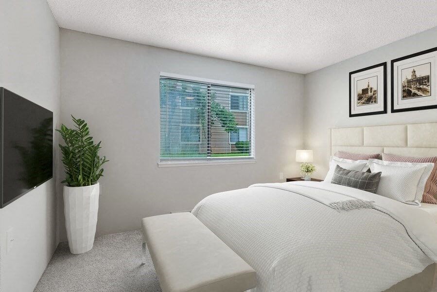 Model bedroom with carpeting with queen-size bed