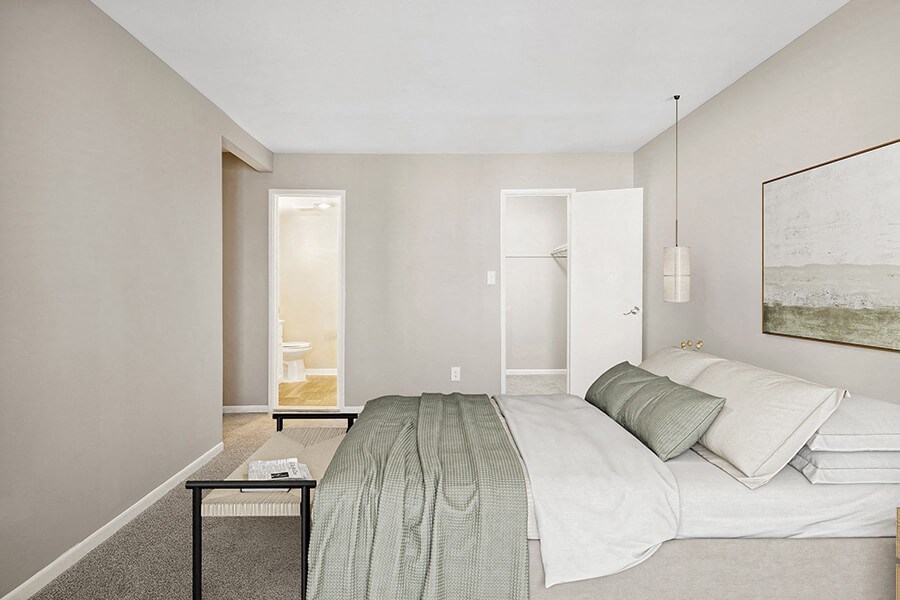 Model Bedroom with Carpet, Walk in Closet and attached Bathroom at Spring Parc Apartments in Silver Spring, MD.