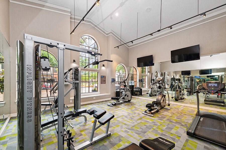 Community Fitness Center with Equipment at Dallas North Park Apartments in Dallas, TX.