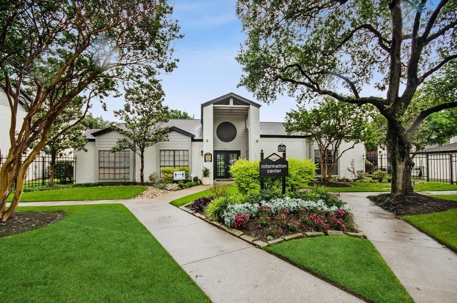 Clubhouse with a sidewalk and trees in front of it