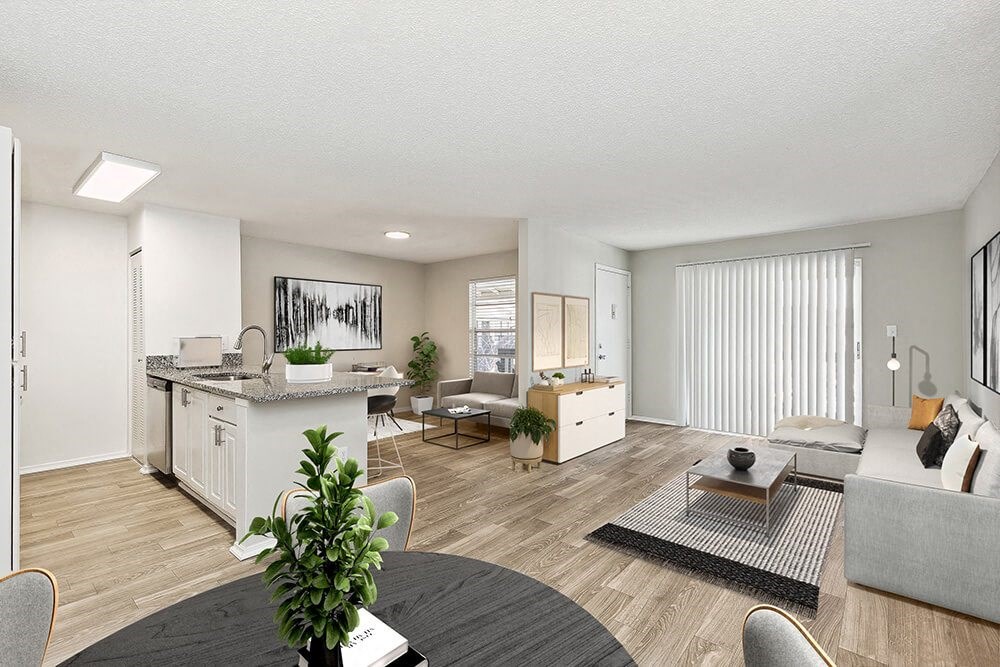 Model Living Room and Kitchen/Dining Room Area with Wood-Style Flooring at Seven Lakes at Carrollwood Apartments in Tampa, FL.