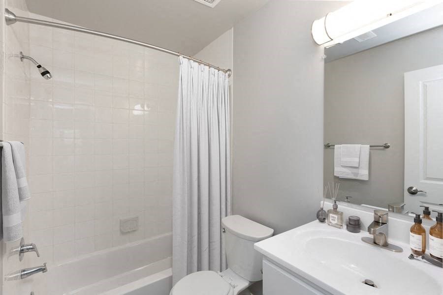 Model bathroom with a toilet, sink, and bathtub and Brightwood Forest Apartments