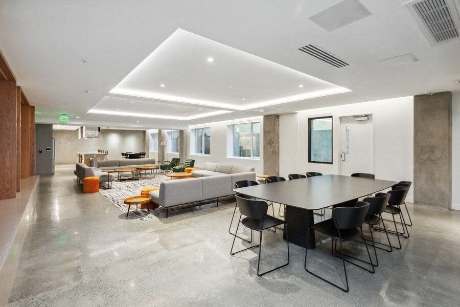 Community lounge with sofas and tables at TL Residences