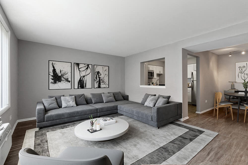 Model Living Room with Wood-Style Flooring at Midpointe Apartments in Chicago, IL.