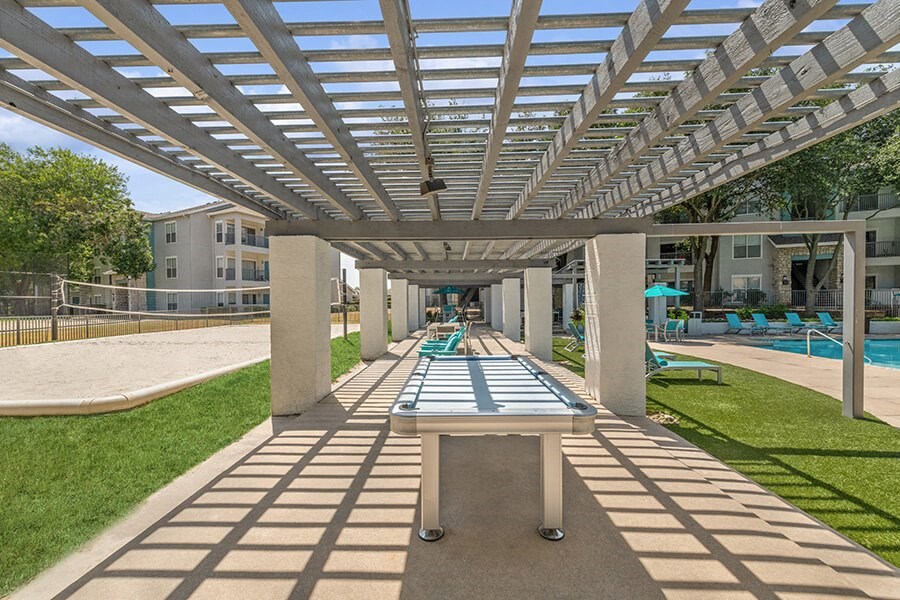 Outdoor Ping Pong Table and Pool Area at Essence Apartments in Dallas, TX.
