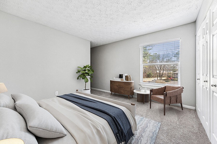 Model Bedroom with Carpet and Window View at Paramont Apartments in Duluth, GA.