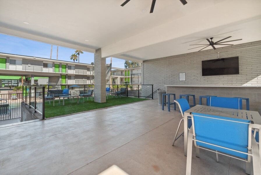 Covered outdoor lounge space near pool