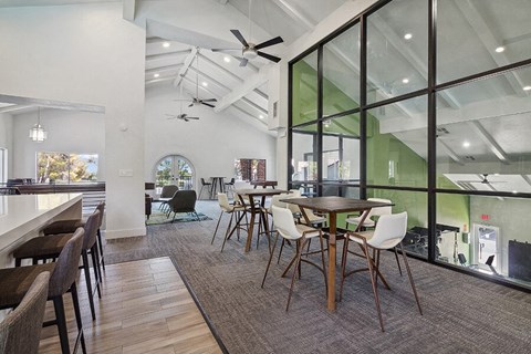 Community Clubhouse with Lounge Furniture and Kitchenette Area at Meadow Ridge Apartments located in Las Vegas, NV.
