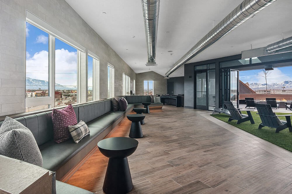 Booth seating and loungers in convertible resident lounge area at Post District Residences in Downtown Salt Lake City, Utah