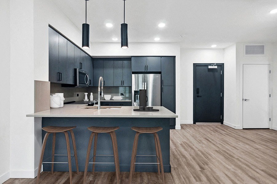 Model kitchen with stainless steel appliances at Post House North located in Post District Residences in downtown Salt Lake City, Utah