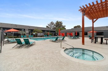Poolside hot tub and lounge chairs
