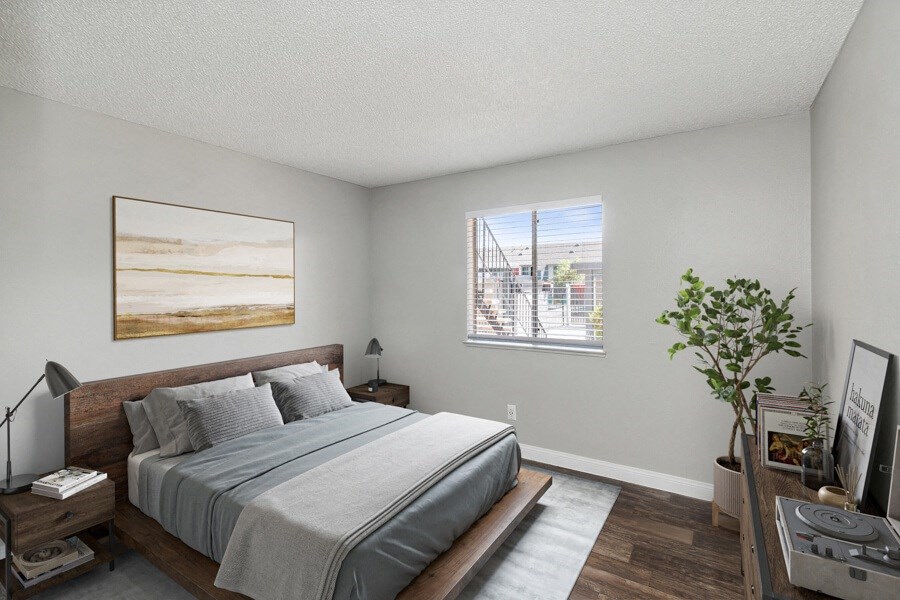 a bedroom with a large bed and a window