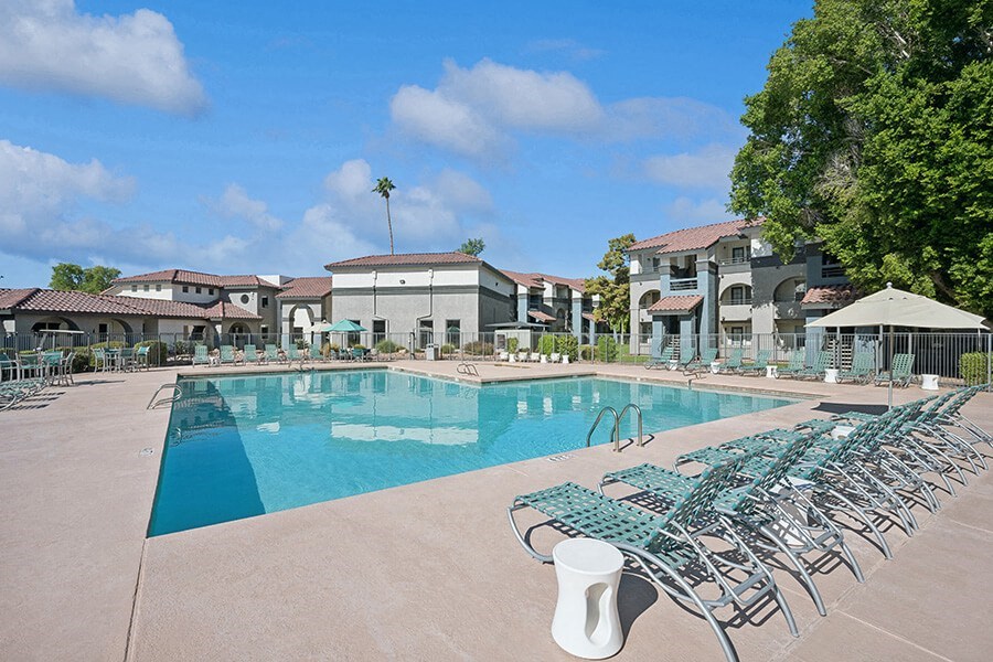 Community Swimming Pool with Pool Furniture at Stillwater Apartments located in Glendale, AZ.