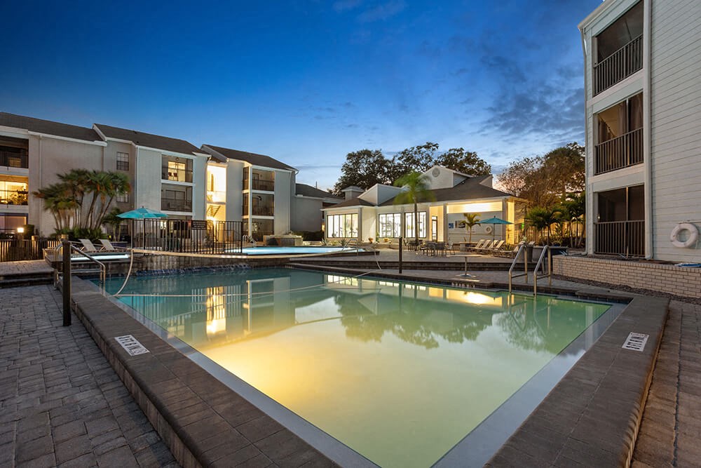 Community Swimming Pool with Pool Furniture at Haven at Water's Edge Apartments in Tampa, FL.