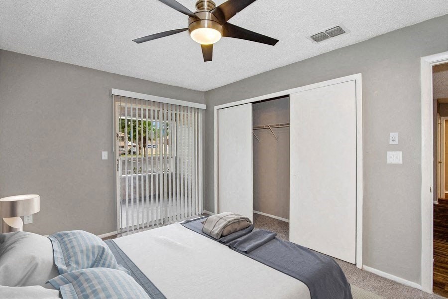 Model bedrrom with balcony sliding door and walk in closet