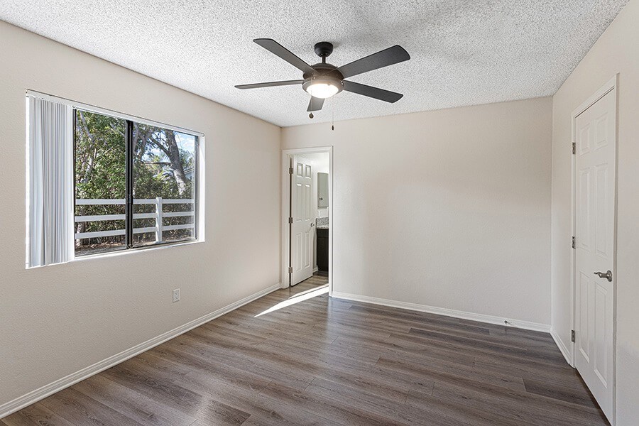 Model Bedroom with Wood-Style Flooring at Santa Fe Ranch Apartments located in Carlsbad, CA.