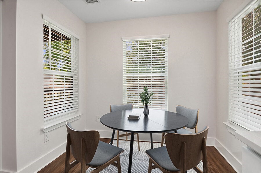 Model Dining Room with Wood-Style Flooring at Park at Caterina Apartments located in Charlotte, NC.