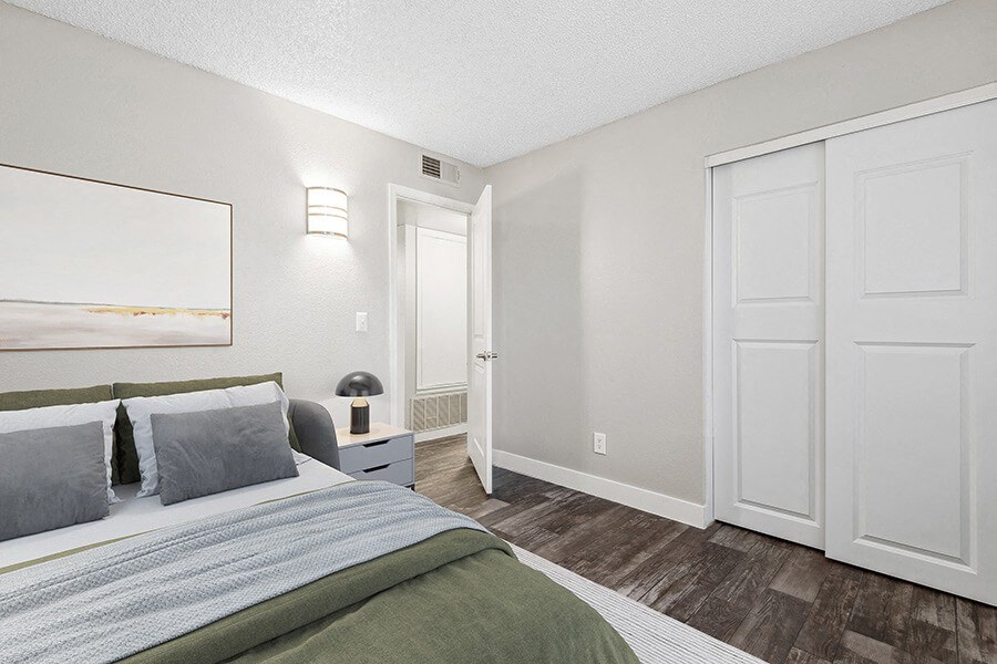 Model Bedroom with Wood-Style Flooring and Closet at Peaks on 4th Apartments in Avondale, AZ.