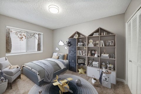 Hillsboro, OR, Apartments Near Nike World Headquarters - Terraces at Tanasbourne - Children's Bedroom With A Twin Bed, House-Shaped Bookshelf Filled With Toys And Decor.