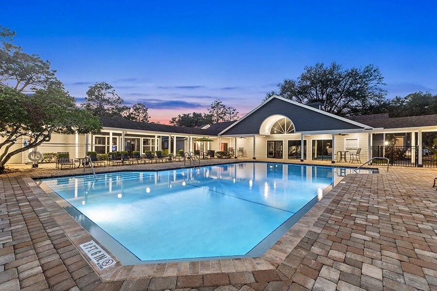 Community Swimming Pool with Pool Furniture at Retreat at Crosstown Apartments in Riverview, FL.